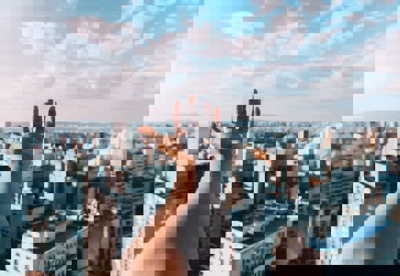 Hand above buildings